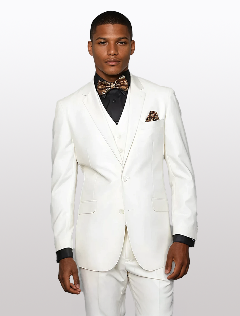 Man in a Statement Men's Off-White Solid Modern Fit 100% Wool Vested Suit with a black shirt and patterned bow tie, stands against a plain background.