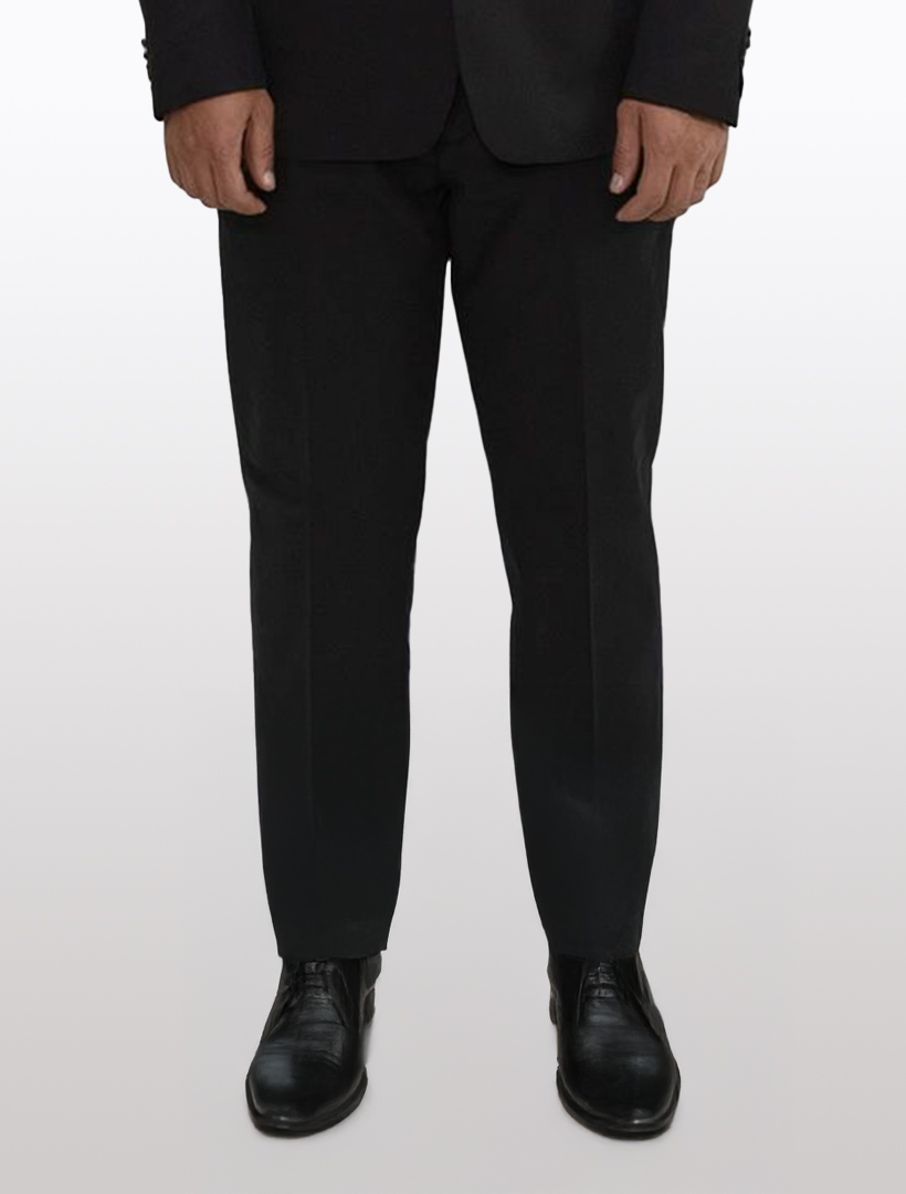 Wearing FUBU Black Separates Slim-Fit Pants from Fubu The Colle and black shoes, a person embodies a professional look against a plain light background.