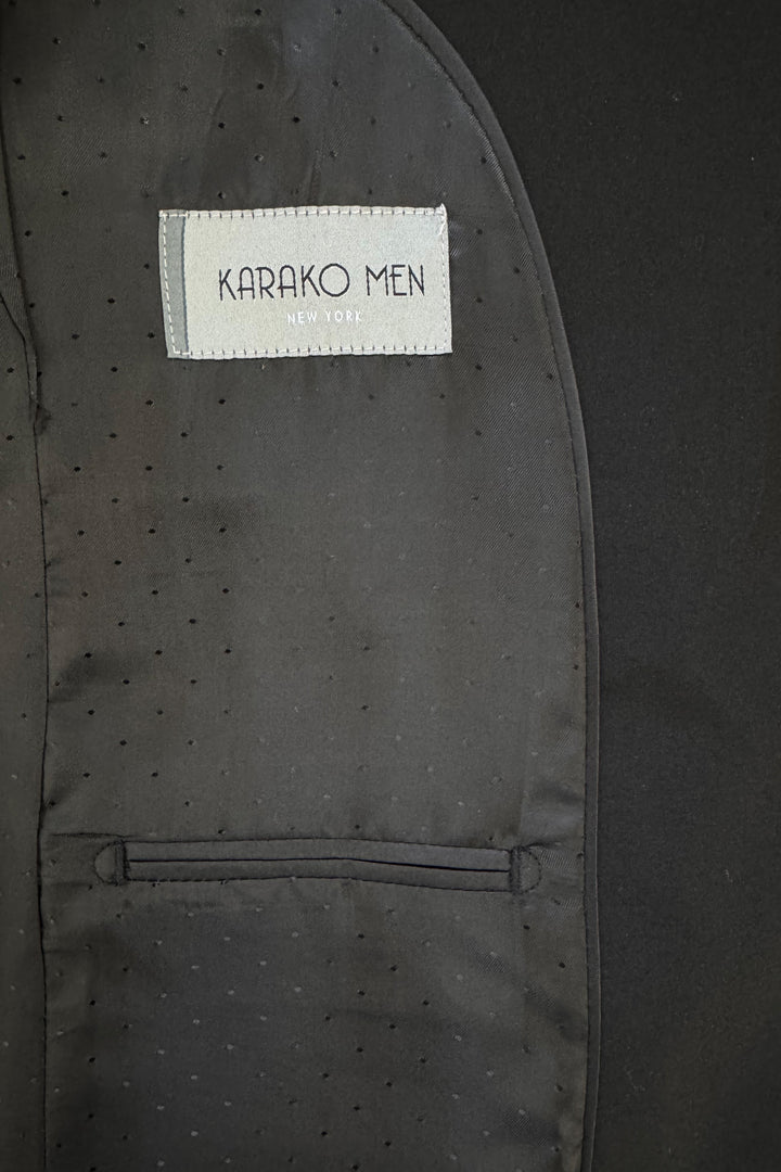 Close-up of the inside lining of a Karako Men Mens Black Suit jacket, featuring the brand label above a small pocket.