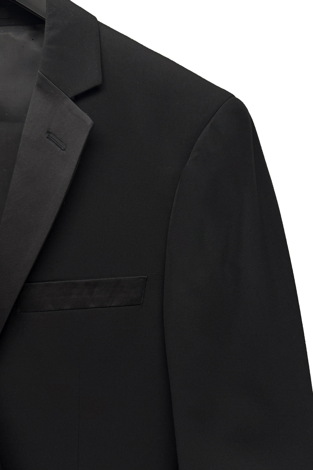 Close-up of the FUBU Classic Notch Lapel Black Tuxedo by Fubu The Colle, slim fit with a notched lapel and breast pocket, shown against a white background.