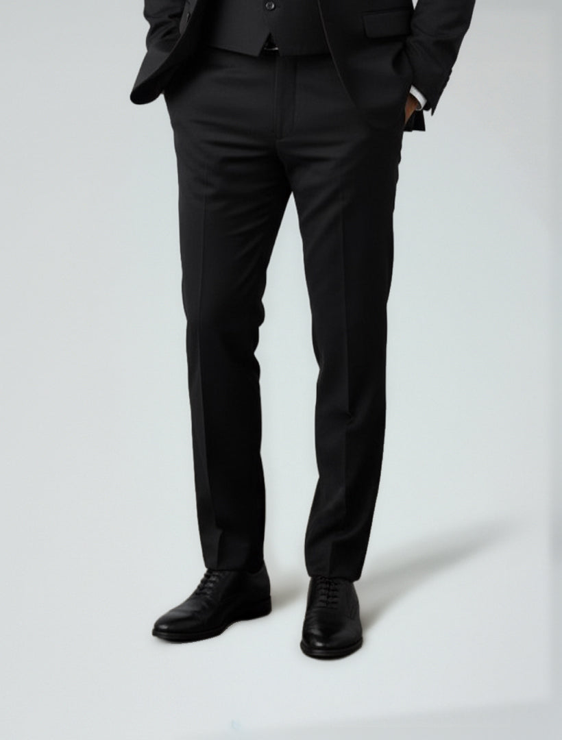 A person wearing FUBU Black Separates Slim-Fit Pants by Fubu The Colle stands with hands in pockets against a light background, highlighting refined office style.
