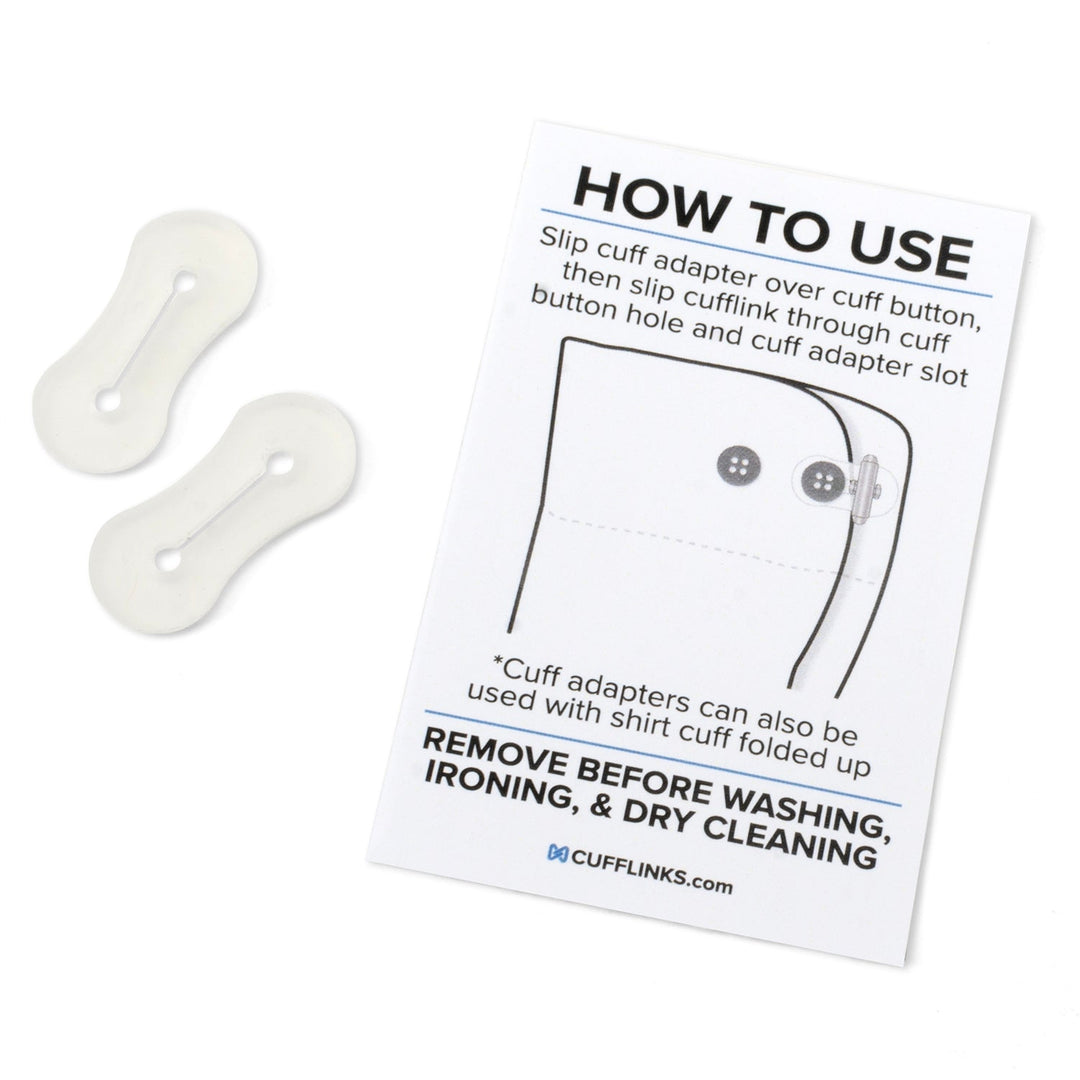 Two translucent silicone Cufflink Adapters placed next to an instructional card illustrating how to attach them to a dress shirt cuff.
