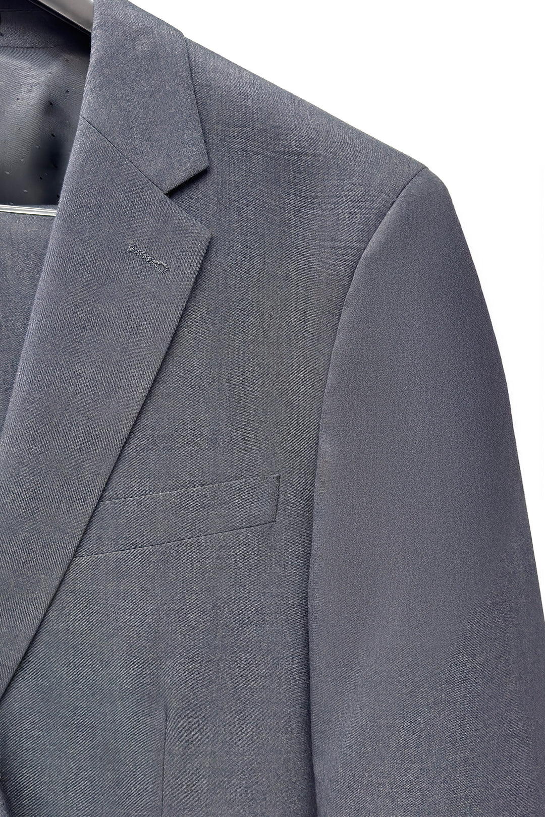 Close-up of the Mens Charcoal Suit by Karako Men on a hanger, showcasing the lapel, chest pocket, and shoulder details.