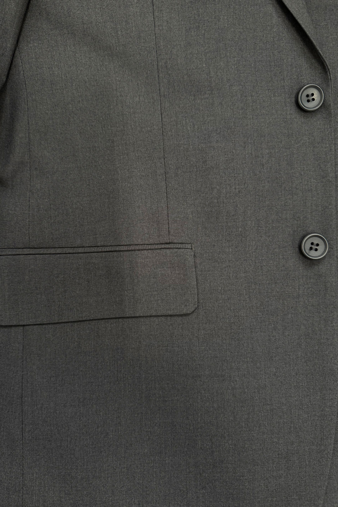 Close-up of the Karako Men Mens Charcoal Suit jacket, featuring two buttons, a seam, and a flap pocket.