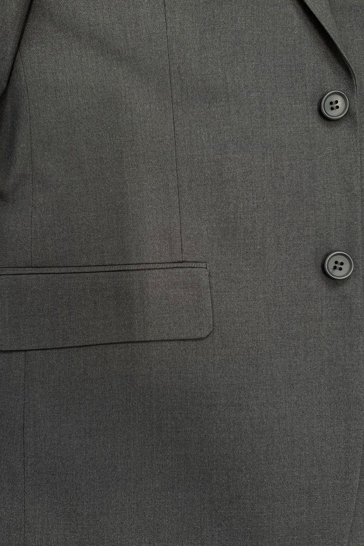 Close-up of the Karako Men Mens Charcoal Suit jacket, featuring two buttons, a seam, and a flap pocket.