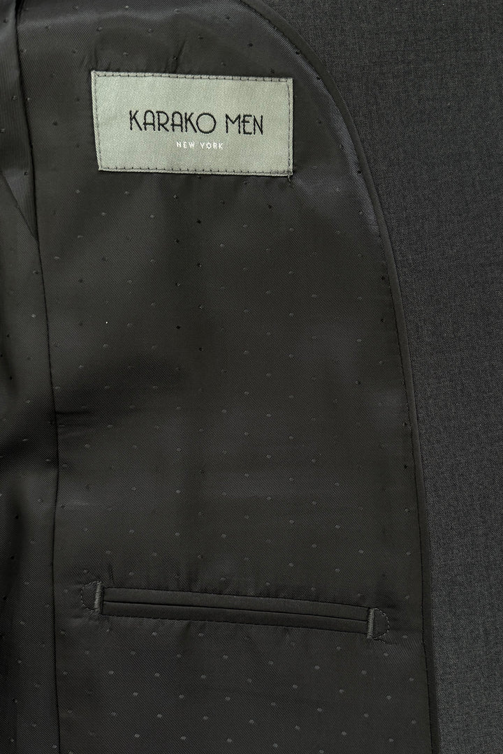 Close-up of the inside lining of a Mens Charcoal Suit by Karako Men, showing a label with the brand name above an interior pocket.