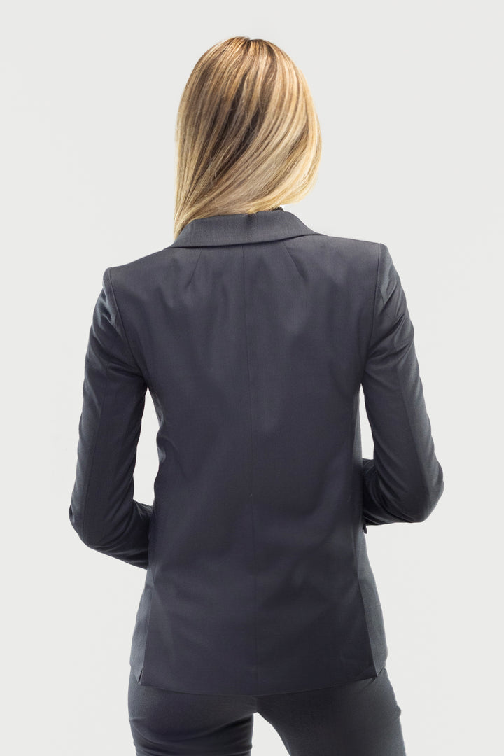 A person with long blonde hair is seen from behind, wearing a Couture 1910 Women&