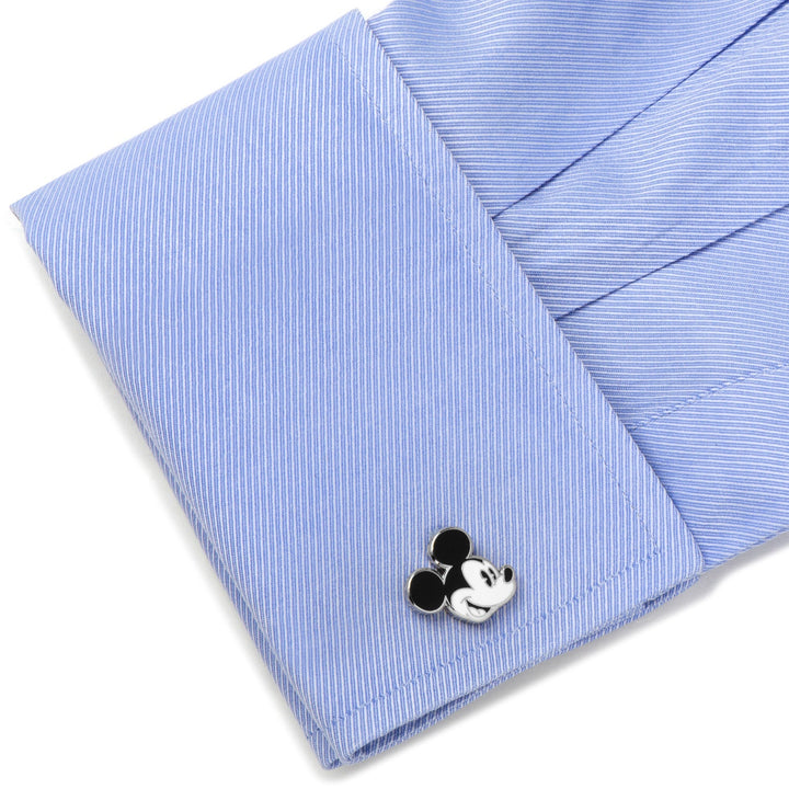 A black and white Mickey Mouse shaped Disney Mickey Mouse Vintage Cufflink fastened to a light blue dress shirt cuff.