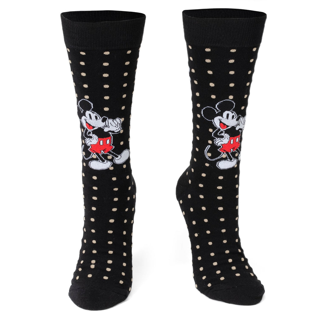 A pair of Disney Mickey Mouse Dot Socks and Blue Lapel Pin Gift Set black socks with tan polka dots and a repeating Mickey Mouse pattern.