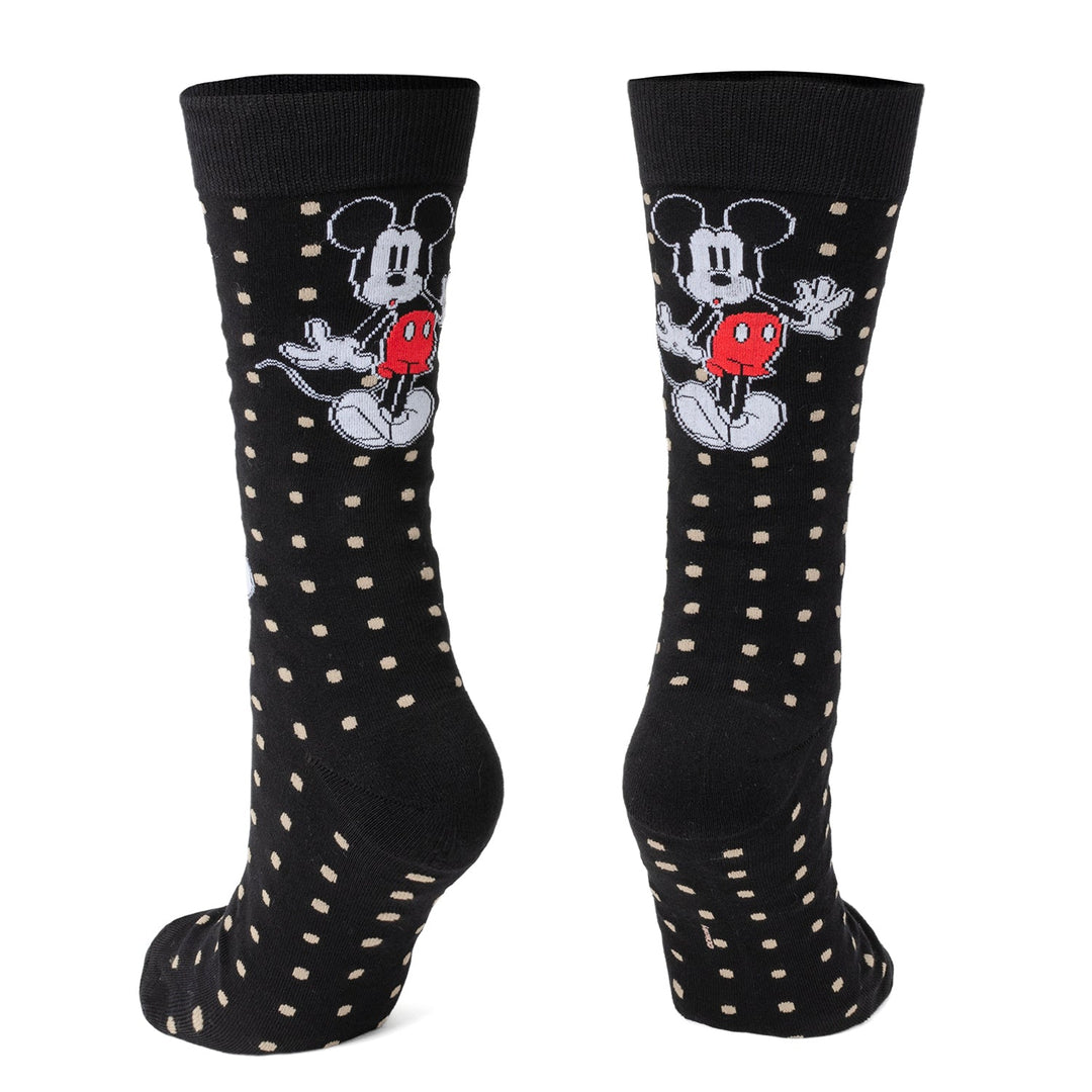 A pair of black Disney Mickey Mouse Dot Socks and Blue Lapel Pin Gift Set socks patterned with tan dots and a Mickey Mouse character design.