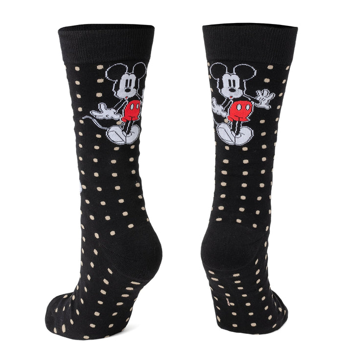 A pair of black Disney Mickey Mouse Dot Socks and Blue Lapel Pin Gift Set socks patterned with tan dots and a Mickey Mouse character design.