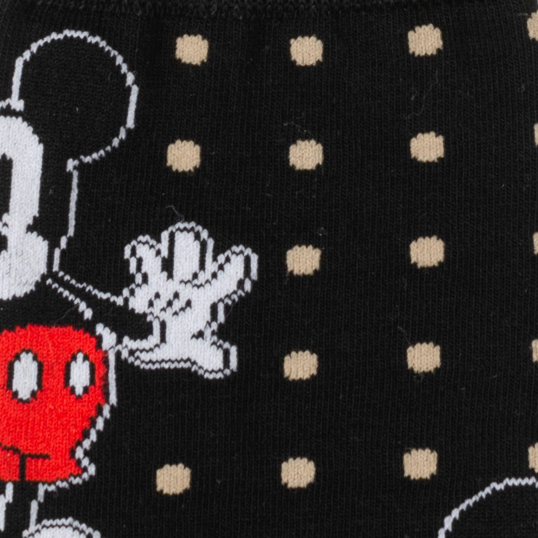 Black fabric socks from the Disney Mickey Mouse Dot Socks and Blue Lapel Pin Gift Set featuring a pattern of beige dots and a Mickey Mouse character.