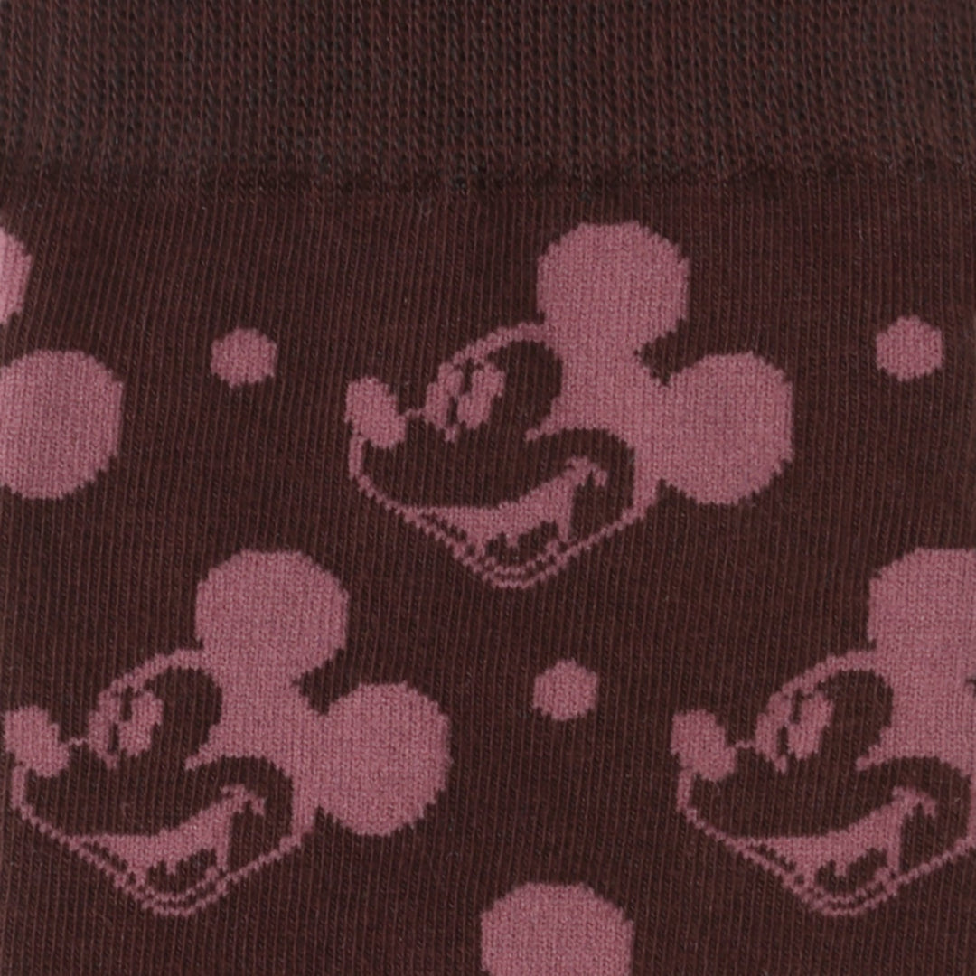 Dark fabric patterned with repeating Mickey Mouse heads and small dots from the Disney Mickey Mouse Red Dot Socks and Blue Lapel Pin Gift Set.