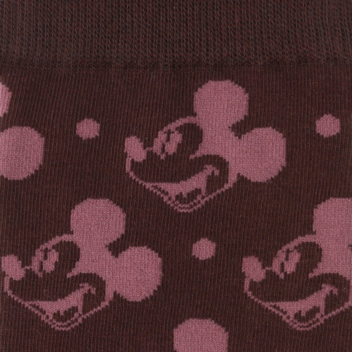 Dark fabric patterned with repeating Mickey Mouse heads and small dots from the Disney Mickey Mouse Red Dot Socks and Blue Lapel Pin Gift Set.