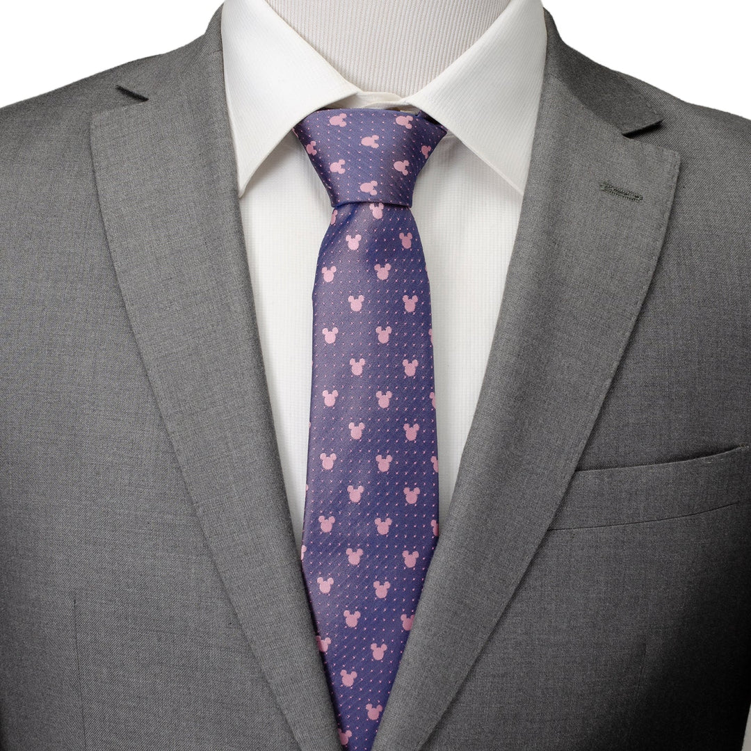 Disney Mickey Mouse Purple and Pink Dot Silhouette Tie, featuring a pattern of pink mouse-ear silhouettes and small white dots, worn with a white dress shirt and grey suit jacket.