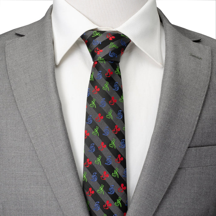 Disney Mickey and Friends Multi Black Stripe Men’s Tie featuring diagonal gray stripes and small embroidered red, green, and blue Mickey Mouse silhouettes, worn with a white shirt and gray suit jacket.