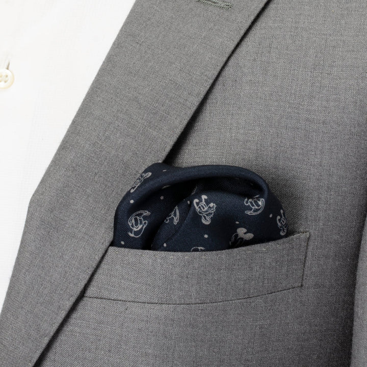 Disney Mickey and Friends Pocket Square in navy silk with a white Mickey Mouse pattern tucked into the chest pocket of a gray suit jacket.