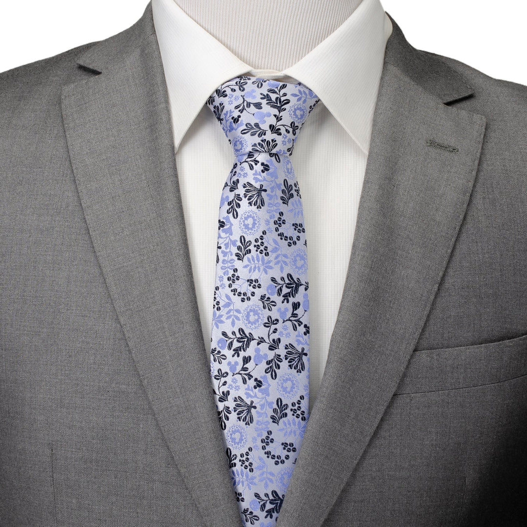 Disney Mickey Mouse Floral Silhouette Blue and White Tie worn with a white shirt and gray suit jacket.