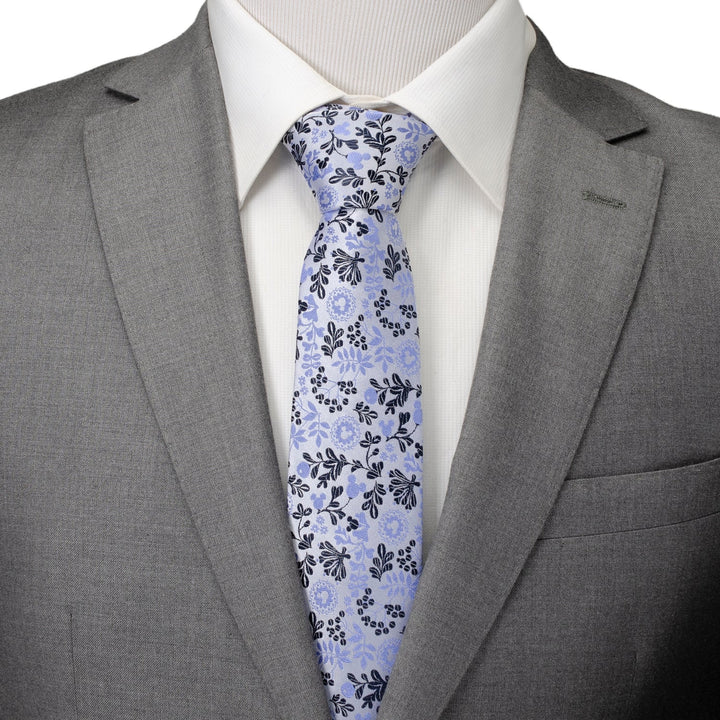 Disney Mickey Mouse Floral Silhouette Blue and White Tie worn with a white shirt and gray suit jacket.