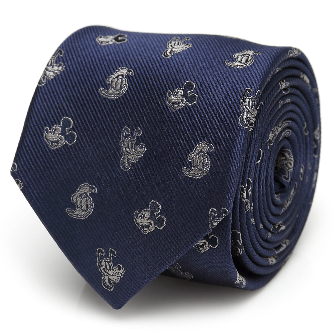 A rolled Disney Mickey and Friends Blue Men’s Tie in navy blue 100% silk, featuring a repeating light grey silhouette pattern.