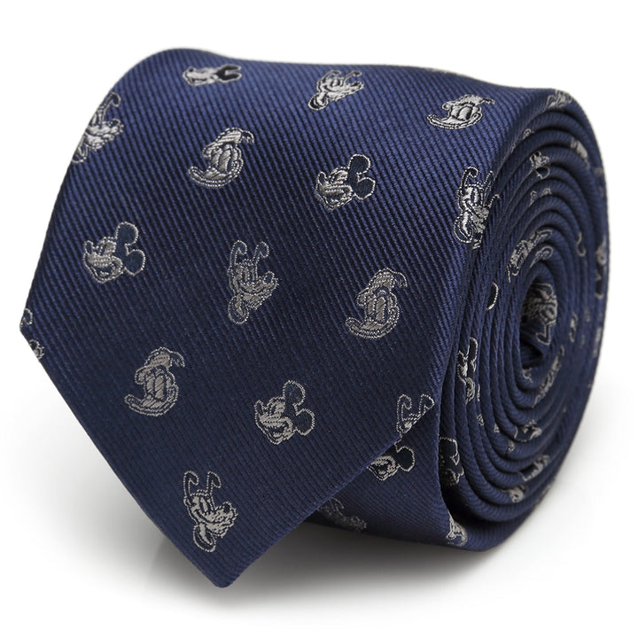 A rolled Disney Mickey and Friends Blue Men’s Tie in navy blue 100% silk, featuring a repeating light grey silhouette pattern.