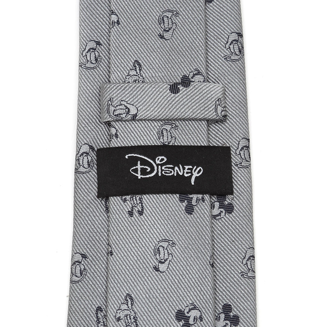 Disney Mickey and Friends Gray Men’s Tie in 100% silk featuring a repeating pattern of small Mickey Mouse silhouettes and a black Disney tie brand label on the back.