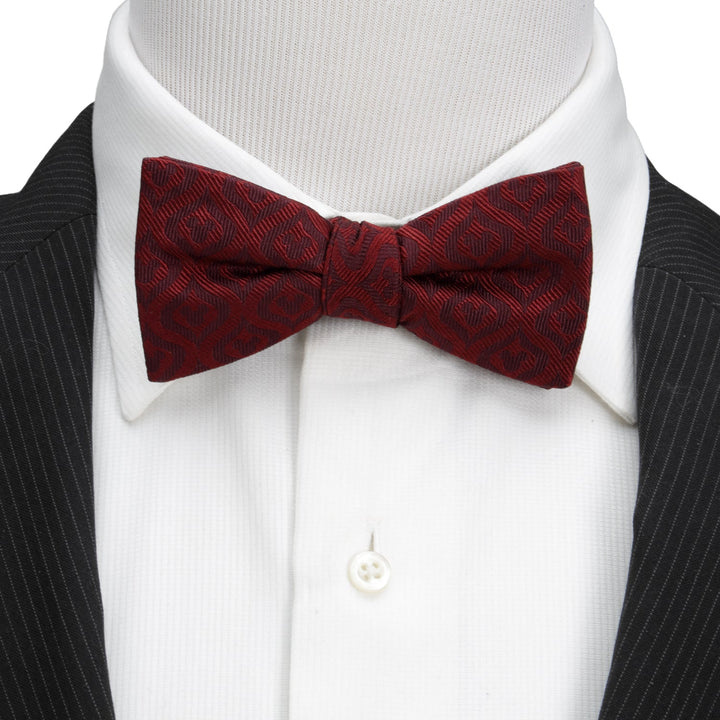 Disney Mickey Mouse Holiday Maroon Bow Tie with a repeating silhouette pattern, worn on a white collared shirt and black pinstriped suit jacket.