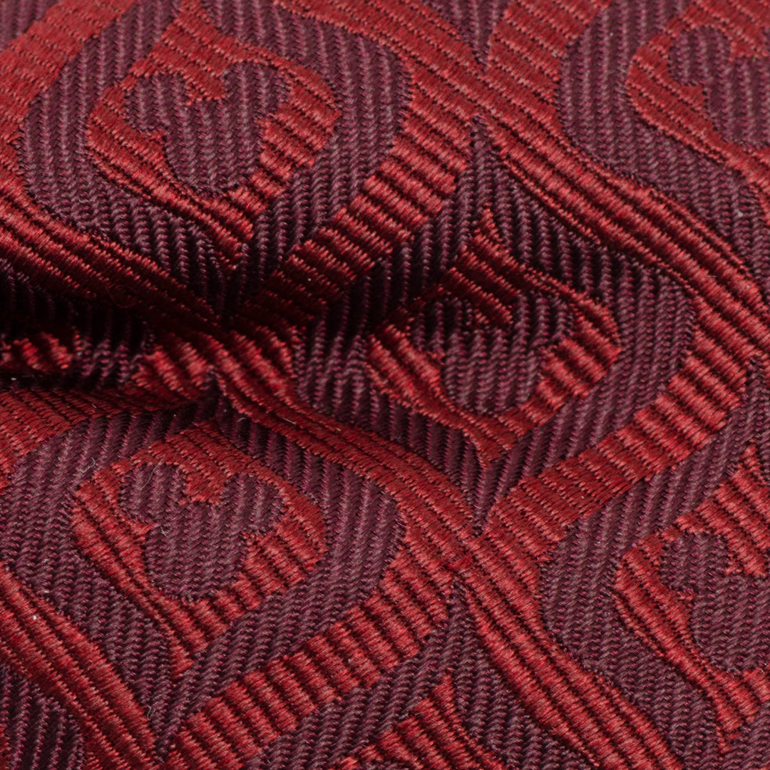 Disney Mickey Mouse Holiday Maroon Bow Tie made of maroon fabric with a repeating woven pattern of Mickey Mouse silhouettes.
