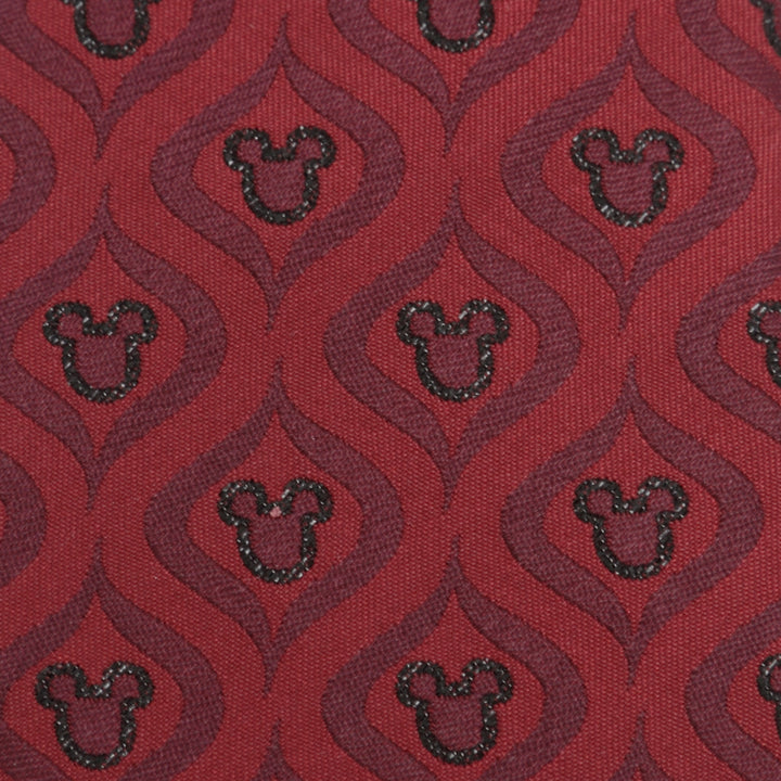 Disney Mickey Mouse Holiday Metallic Black Silk Men’s Tie in red fabric with a festive pattern of glittering dark Mickey Mouse silhouettes inside wavy, dark red geometric shapes.