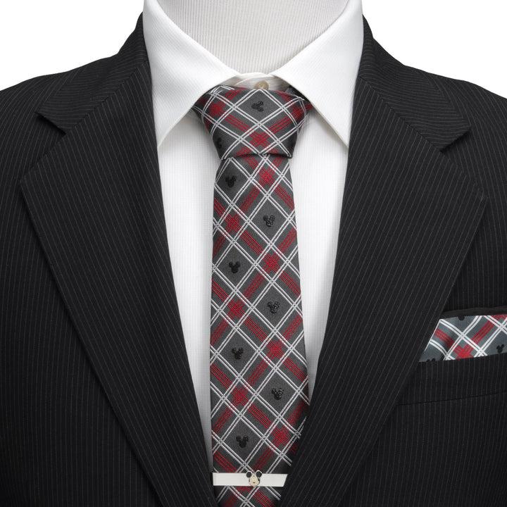 Disney Mickey Mouse Holiday Gray Plaid Silk Men’s Tie in gray and red plaid with small Mickey Mouse silhouettes, worn with a white shirt and black pinstripe suit jacket.