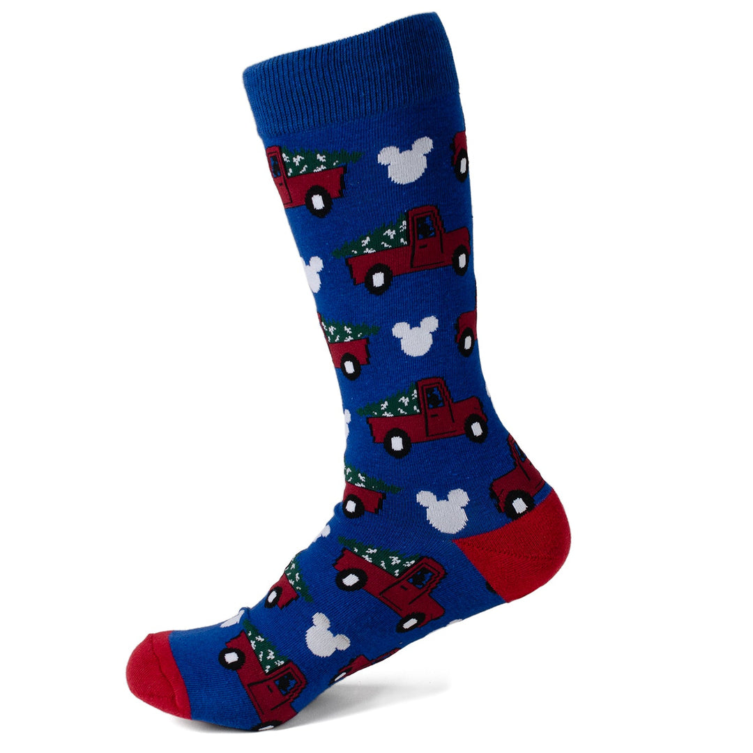Blue crew sock from the Disney Mickey Mouse Holiday Truck Navy Socks and Blue Lapel Pin Gift Set, patterned with red pickup trucks carrying Christmas trees and white Mickey Mouse silhouettes.