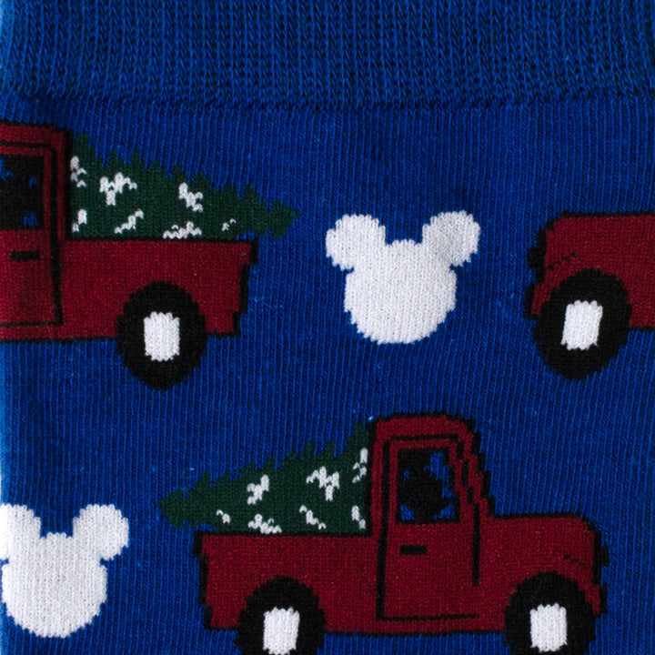 Disney Mickey Mouse Holiday Truck Navy Socks and Blue Lapel Pin Gift Set featuring blue socks with a repeating pattern of red pickup trucks carrying evergreen trees and white Mickey Mouse icon silhouettes.