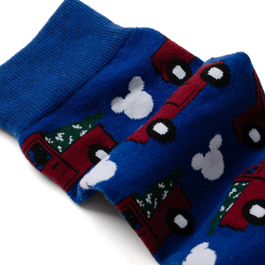 Disney Mickey Mouse Holiday Truck Navy Socks and Blue Lapel Pin Gift Set featuring a pattern of red trucks carrying Christmas trees and white Mickey Mouse silhouettes.