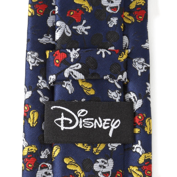 Disney Mickey Mouse Action Navy Men’s Tie in navy blue with a pattern of small character figures and a black Cufflinks.com brand label on the back.