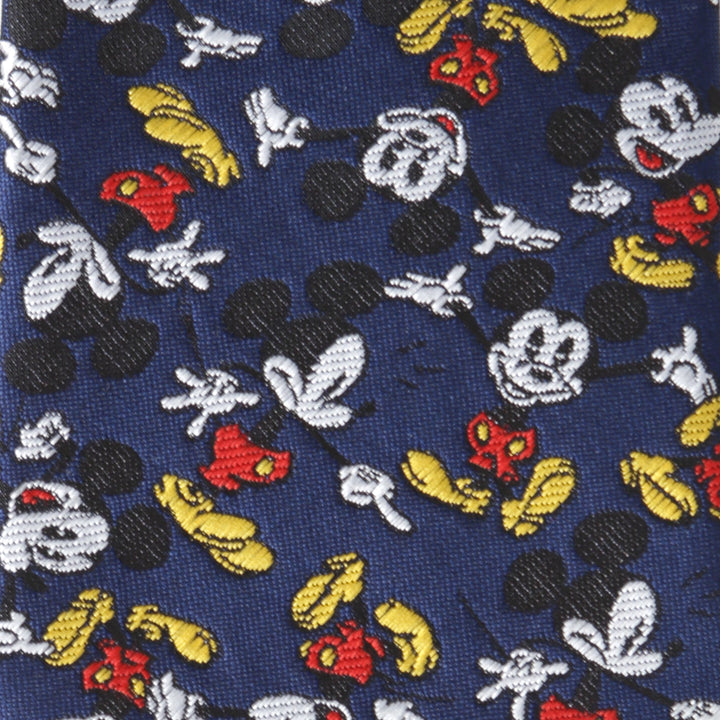 Disney Mickey Mouse Action Navy Men’s Tie in navy blue featuring an all-over repeating pattern of cartoon mouse heads, gloves, and shoes.