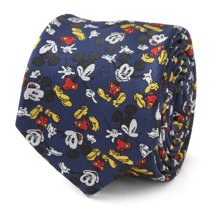 Disney Mickey Mouse Action Navy Men’s Tie featuring a repeating pattern of character heads, gloves, and shoes in red, yellow, black, and white.