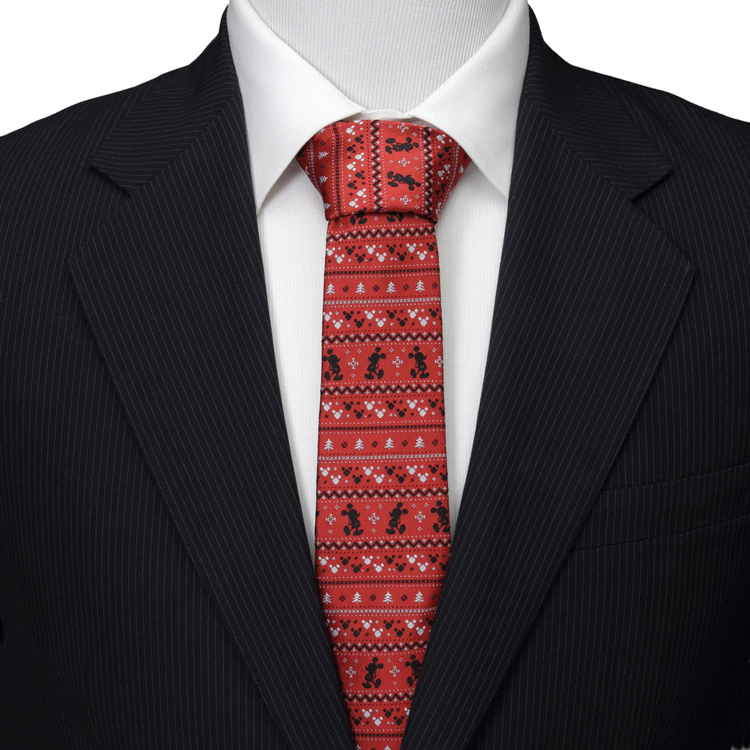 A Disney Mickey Mouse Fair Isle Red Men’s Tie with a festive repeating black Mickey Mouse and white Fair Isle pattern, worn with a white dress shirt and dark suit jacket.