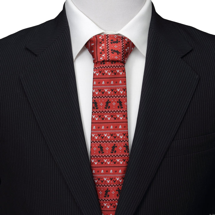 A Disney Mickey Mouse Fair Isle Red Men’s Tie with a festive repeating black Mickey Mouse and white Fair Isle pattern, worn with a white dress shirt and dark suit jacket.