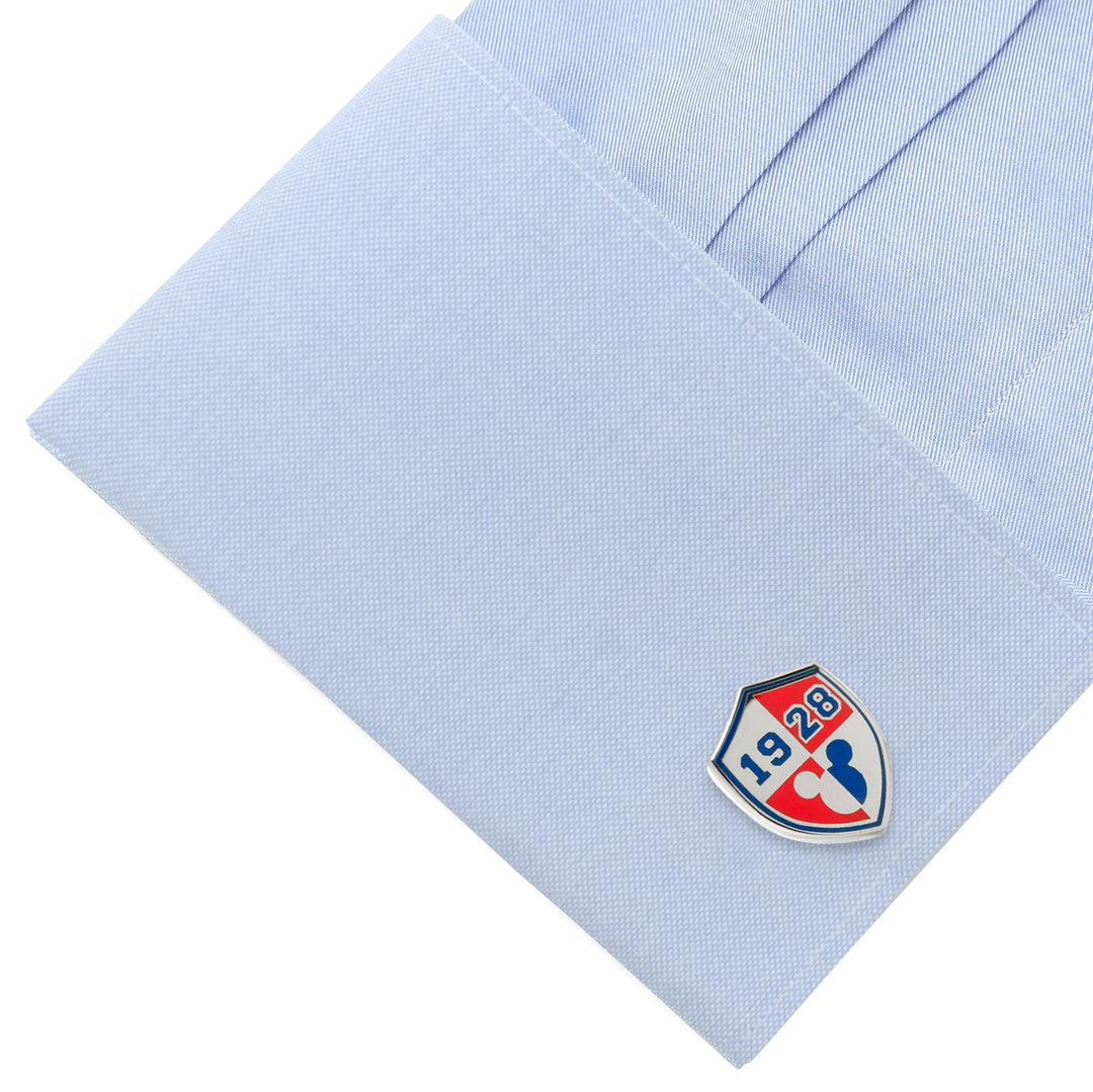 Disney Mickey Mouse 1928 Cufflinks in a shield shape with the numbers 19 and 28, attached to a light blue dress shirt cuff.