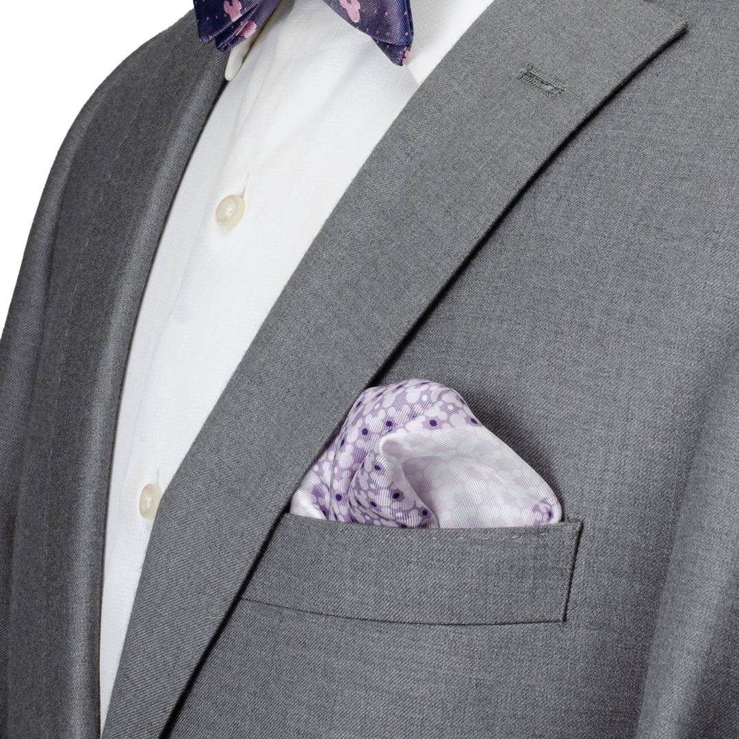 Disney Mickey Mouse Lavender 4 Square Pocket Square featuring a light purple silk fabric with a repeating Mickey Mouse head pattern tucked into the chest pocket of a gray suit jacket.