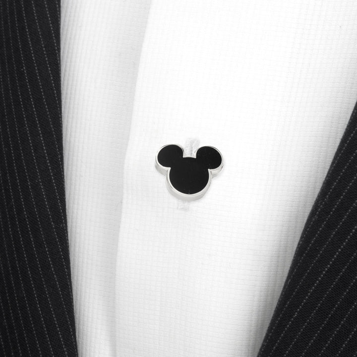 Black and silver Disney Mickey Mouse Silhouette 5-Studs on a white dress shirt under a dark pinstriped jacket.