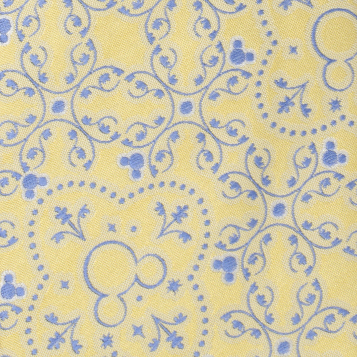 Disney Mickey Mouse Yellow Multi Men’s Tie in yellow with blue ornamental swirls and small Mickey Mouse head silhouettes.