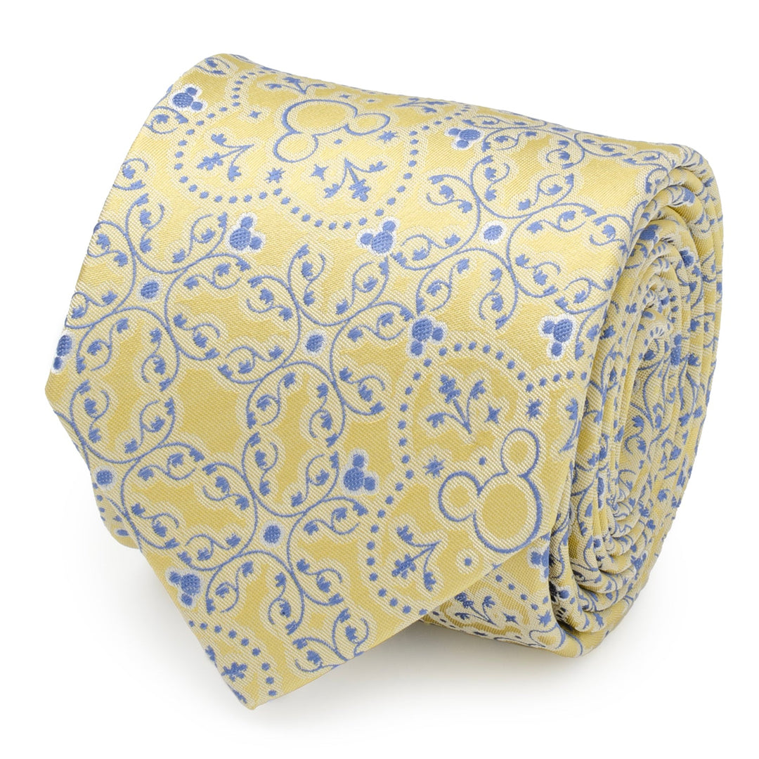 Disney Mickey Mouse Yellow Multi Men’s Tie rolled into a coil with a repeating blue floral pattern and subtle Mickey Mouse head silhouettes.
