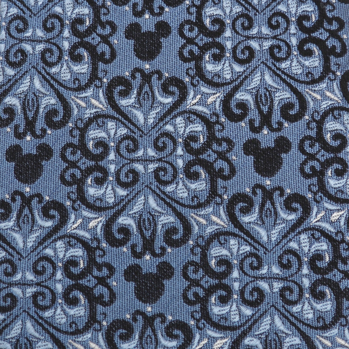 Disney Mickey Mouse Damask Tile Blue Men’s Tie made of blue silk fabric with a repeating black and blue damask pattern featuring integrated Mickey Mouse silhouettes.