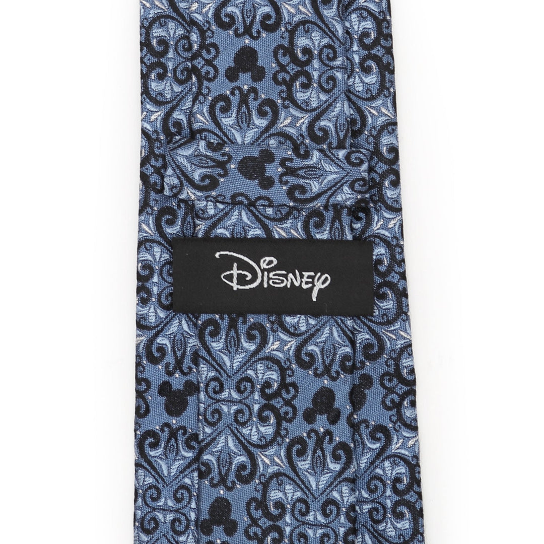 Disney Mickey Mouse Damask Tile Blue Men’s Tie in blue silk, featuring a black damask pattern with hidden silhouettes and a Disney label sewn on the back.
