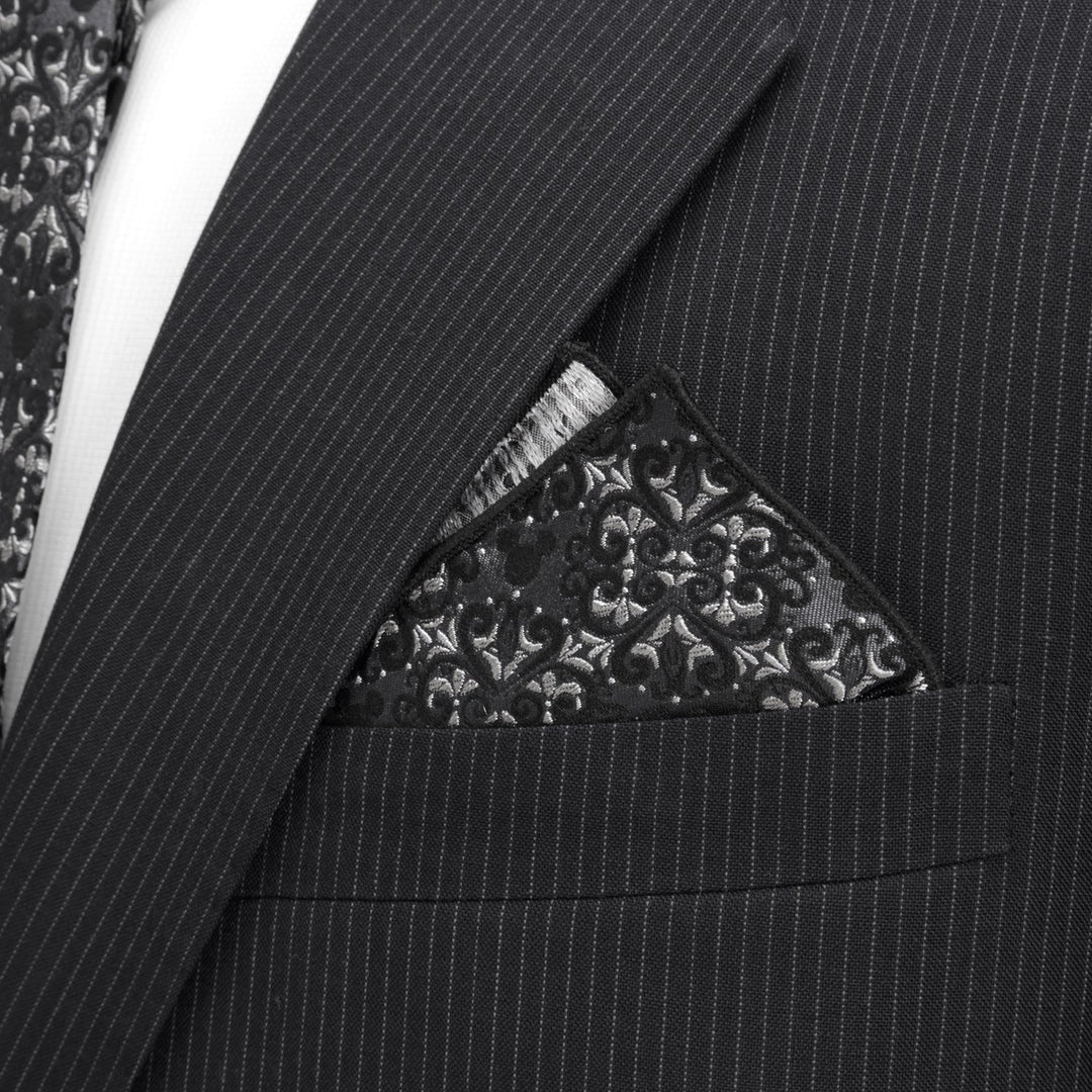 A black and silver Disney Mickey Mouse Damask Pocket Square and Bow Tie Gift Set pocket square featuring Mickey Mouse silhouettes, tucked into the breast pocket of a pinstriped suit jacket.