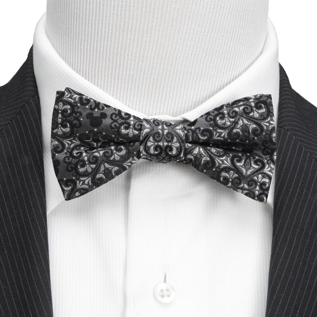 Disney Mickey Mouse Damask Tile Bow Tie in black and grey, worn over a white dress shirt and pinstripe suit jacket.