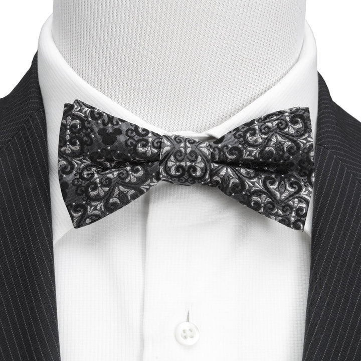 Disney Mickey Mouse Damask Tile Bow Tie in black and grey, worn over a white dress shirt and pinstripe suit jacket.