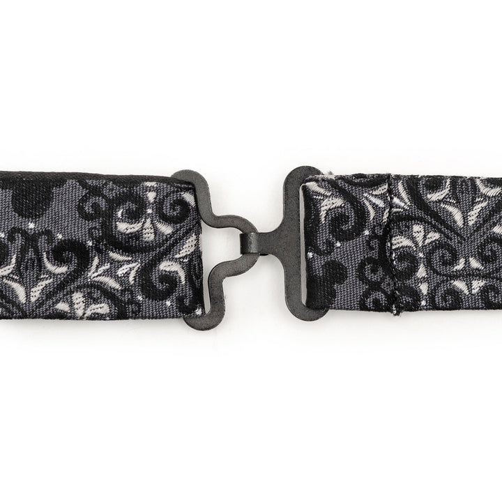 Close-up of a black and grey Disney Mickey Mouse Damask Tile Bow Tie strap joined by a metal hook and eye fastener.