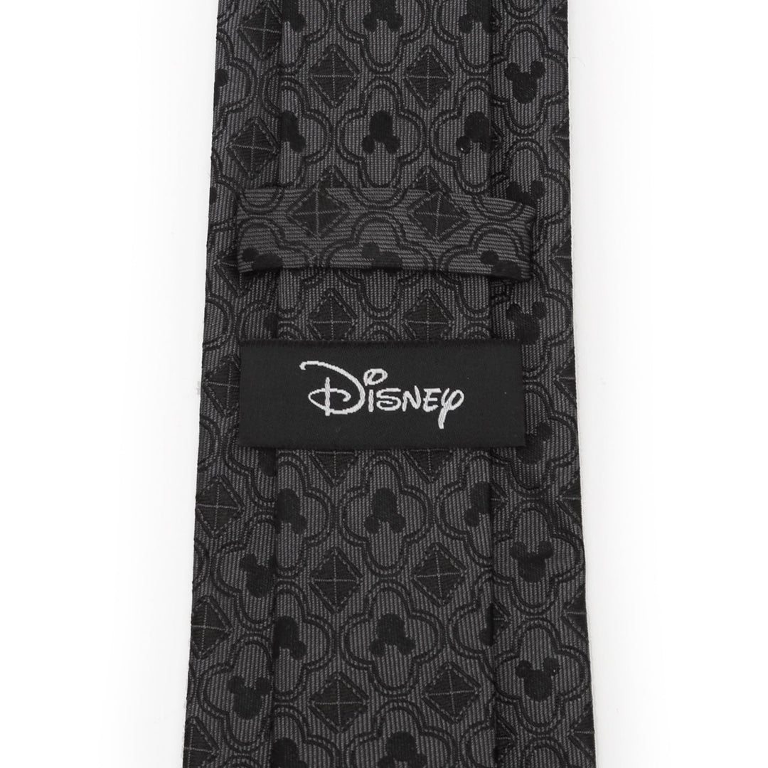 Disney Mickey Mouse Pattern Black Men’s Tie with a gray repeating Mickey Mouse silhouette pattern and a Cufflinks.com brand label on the back.